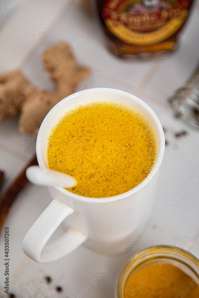 Traditionnal golden latte in a white mug Traditionnal golden latte in a white mug
