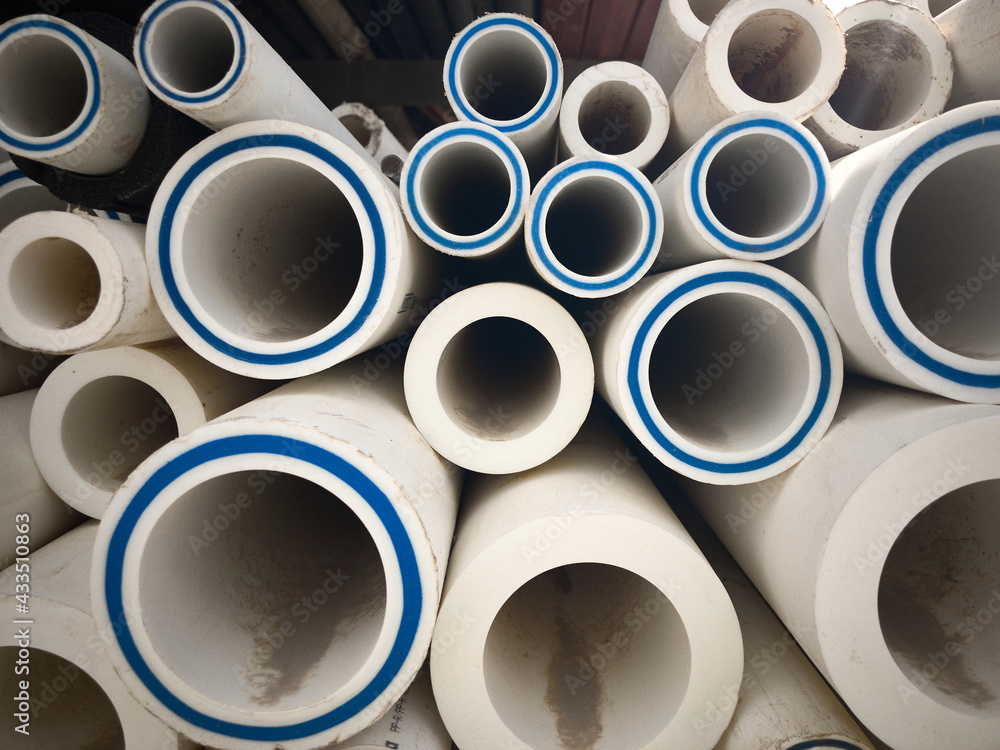 Polypropylene pipes stacked at construction site. Stack of LDPE water pipes. PVC pipes Polypropylene pipes stacked at construction site. Stack of LDPE water pipes. PVC pipes
