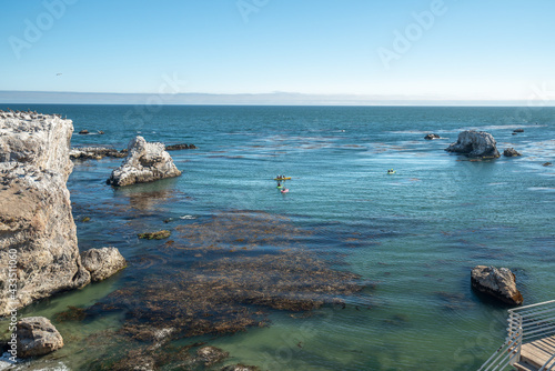 Kayaking along rocky shore, Pismo Beach, California coastline © Hanna Tor