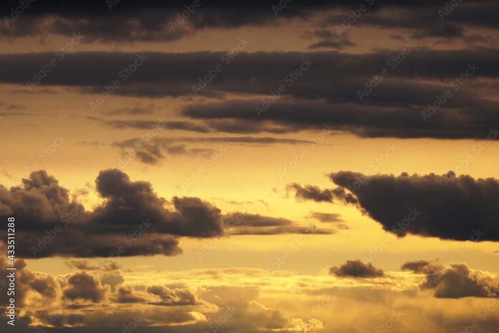  A sky with many clouds, from light and white, illuminated by the sun, to dark thunderclouds.