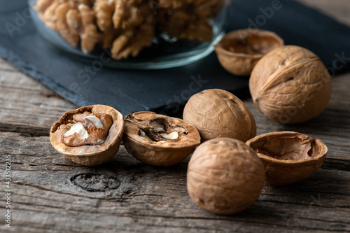 Heap of splited walnuts on rustic wooden table