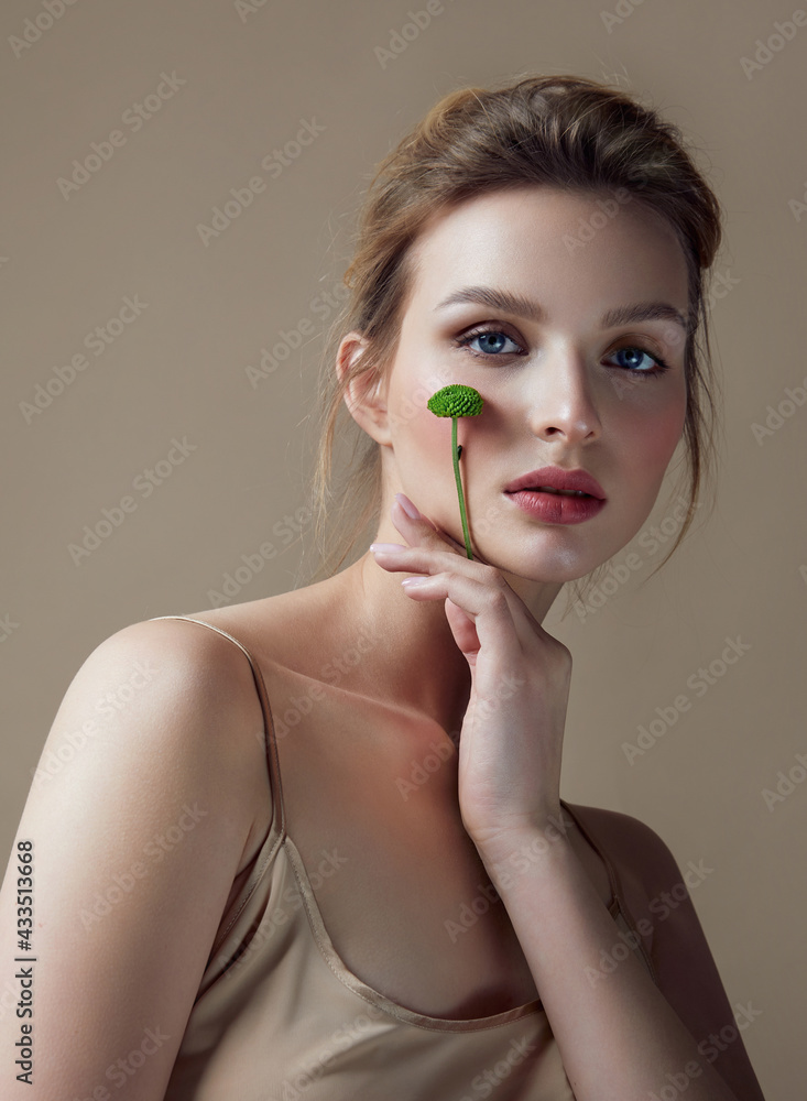 Portrait Young Woman Natural Makeup Woman Holding Green Flower Hand Natural cosmetics. Cosmetology and rejuvenation. Portrait Young Woman Natural Makeup Woman Holding Green Flower Hand Natural cosmetics. Cosmetology and rejuvenation.