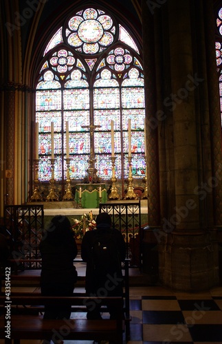 people praying inside a church with a glass case in the background © LPGmoments