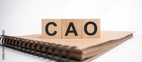 Text cao on the wooden cubes and craft colored notepad on the white background photo
