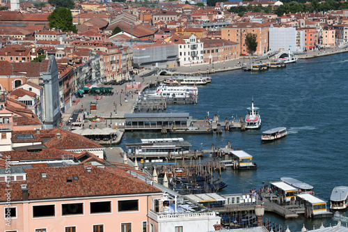Elevated view of waterfront in Venice, with piers and water bus stop in a tranquil day after end of lockdown for covid-19 pandemic. Only a few tourists are present in th historic city. Venice, Italy. © M.Scarselletta
