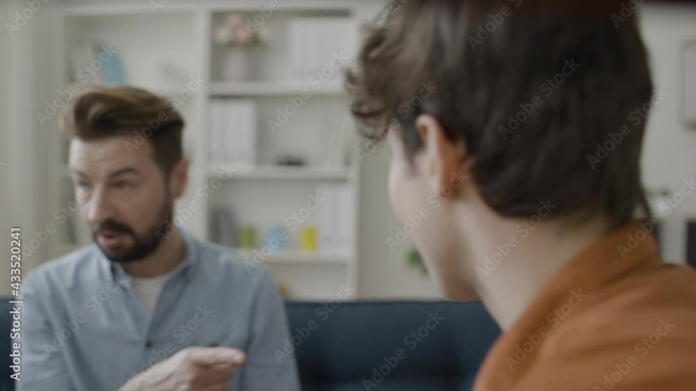 Two angry men discussing relationship problem with psychologist at session Two angry men discussing relationship problem with psychologist at session