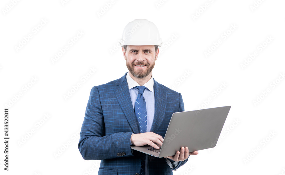 happy man in suit and safety helmet wotking on computer online isolated on white, agile business. happy man in suit and safety helmet wotking on computer online isolated on white, agile business.