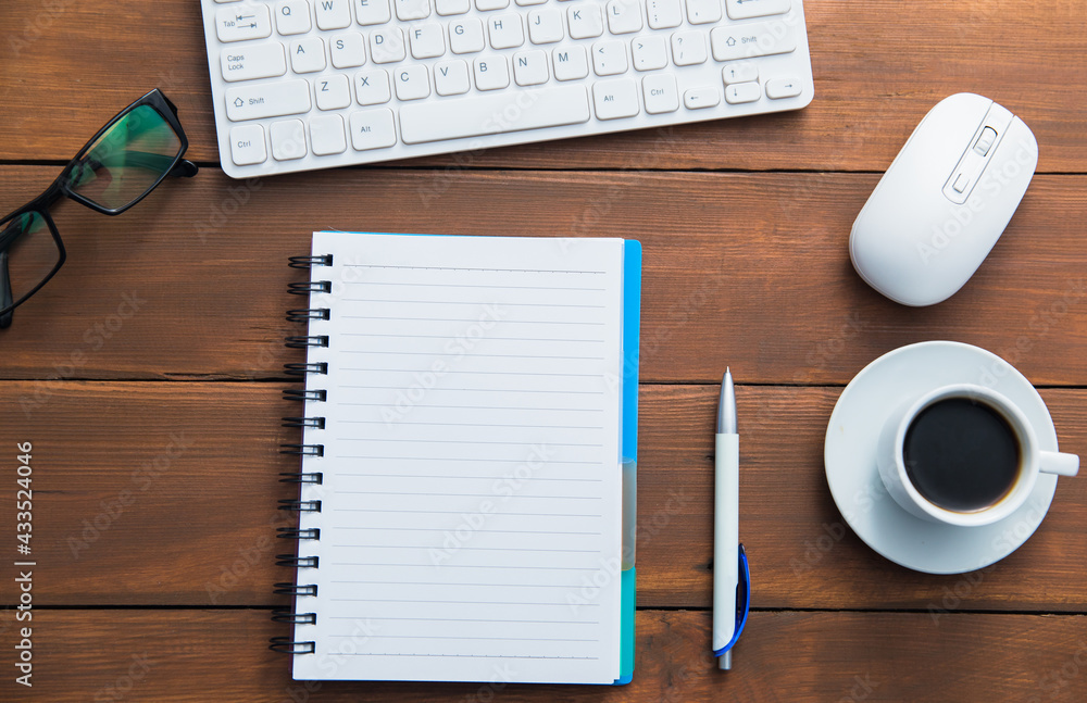 computer and notepad with cup of coffee computer and notepad with cup of coffee