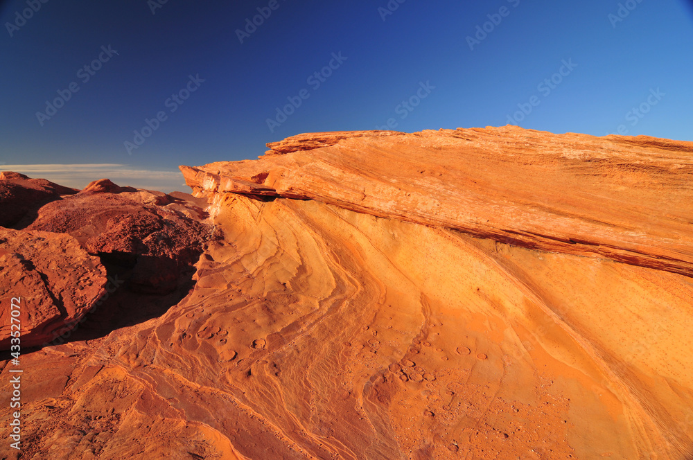 Fototapeta premium Eons of pock marked and striated rocks in the Arizona desert