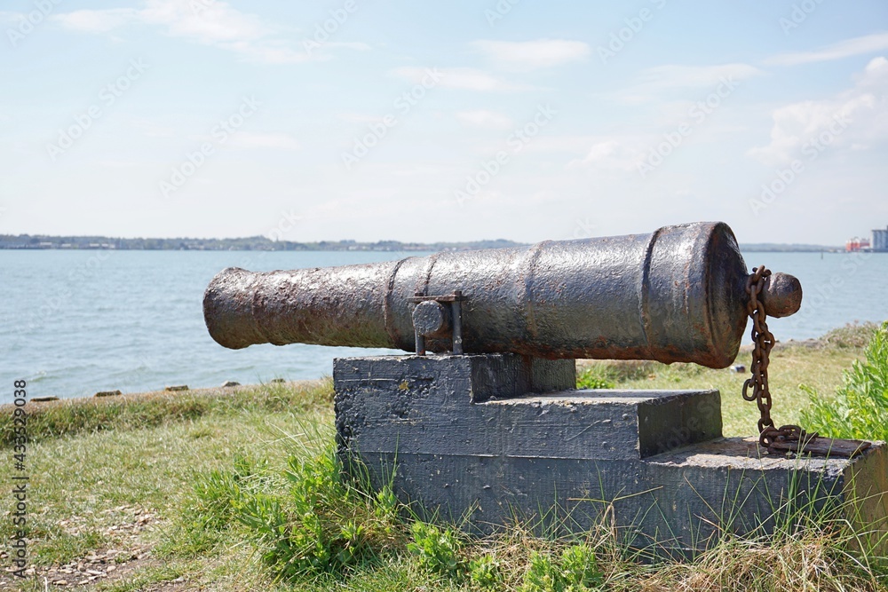 Old cannon on block faces river. Old cannon on block faces river.