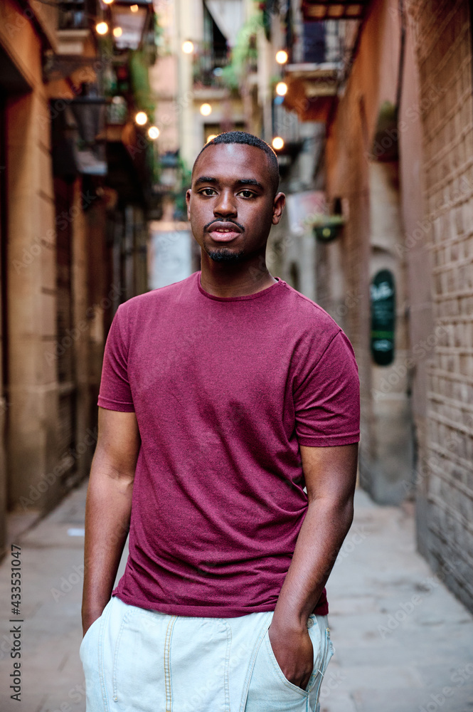 Fototapeta premium portrait of young black man looking directly to camera in outdoor location