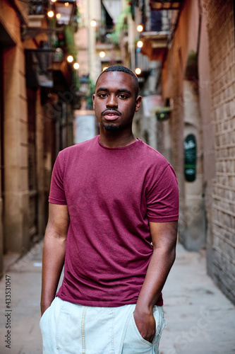 portrait of young black man looking directly to camera in outdoor location