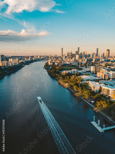 Sunset aerial shot of Brisbane as a City Cat heads towards the city on the Brisbane River photo