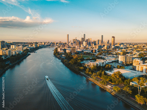 Sunset aerial shot of Brisbane as a City Cat heads towards the city on the Brisbane River photo