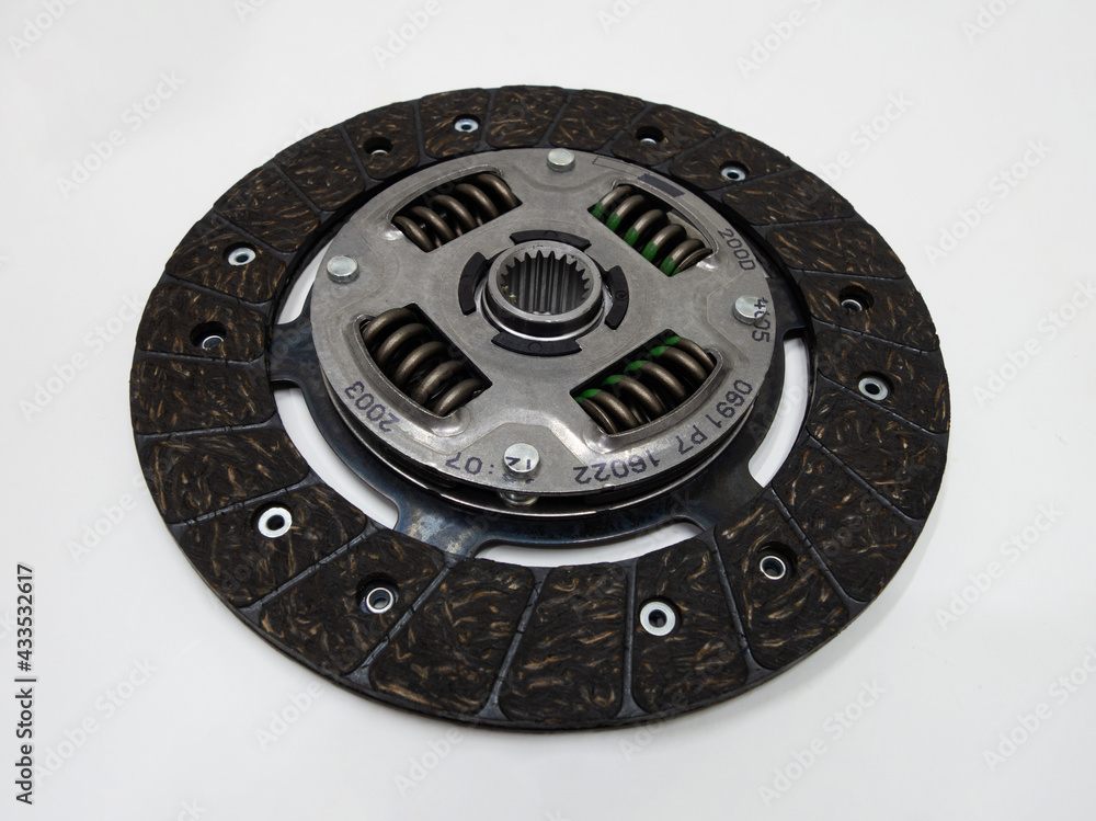 Naklejka premium Auto parts: isolated close-up photo of new clutch plate on a white background