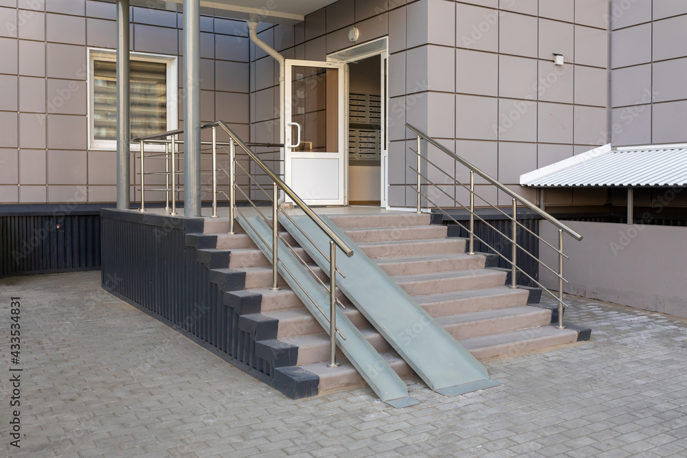 Entrance group with a ramp of a multi-storey residential building ...