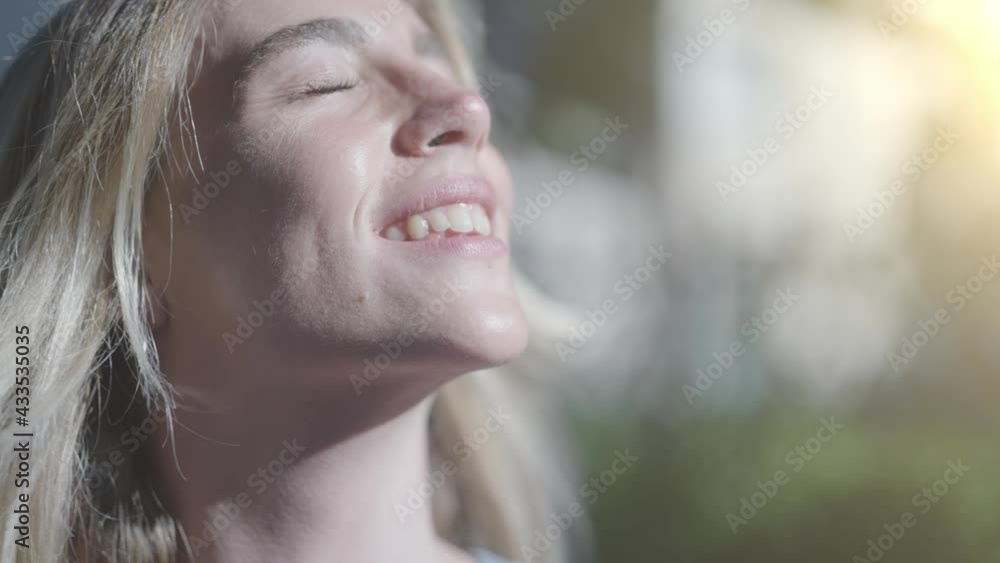 Portrait closeup of a pretty happy young woman shows her face in the sun to welcome the summer. Portrait closeup of a pretty happy young woman shows her face in the sun to welcome the summer.