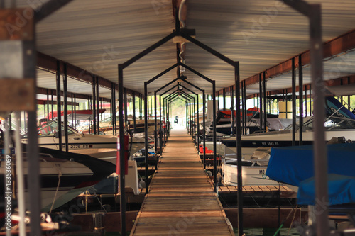 Boat dock on water with boats, one point perspective