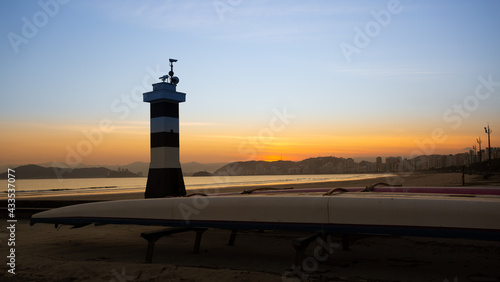 Panoramic view of the city of Santos with Hawaiian Outrigger and the lighthouse in the foreground with a wonderful sunset