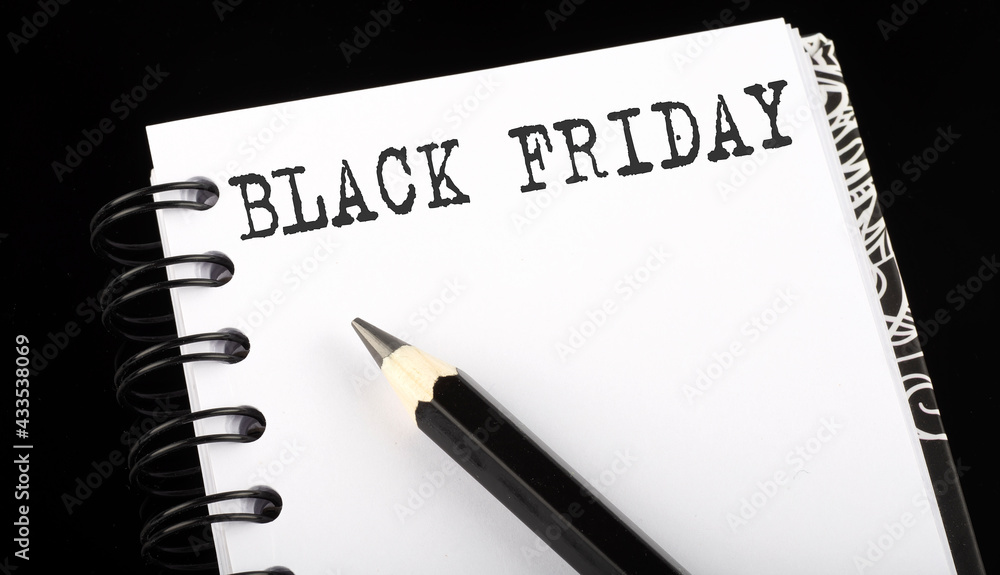 Black Friday written text in small notebook on a black background Black Friday written text in small notebook on a black background