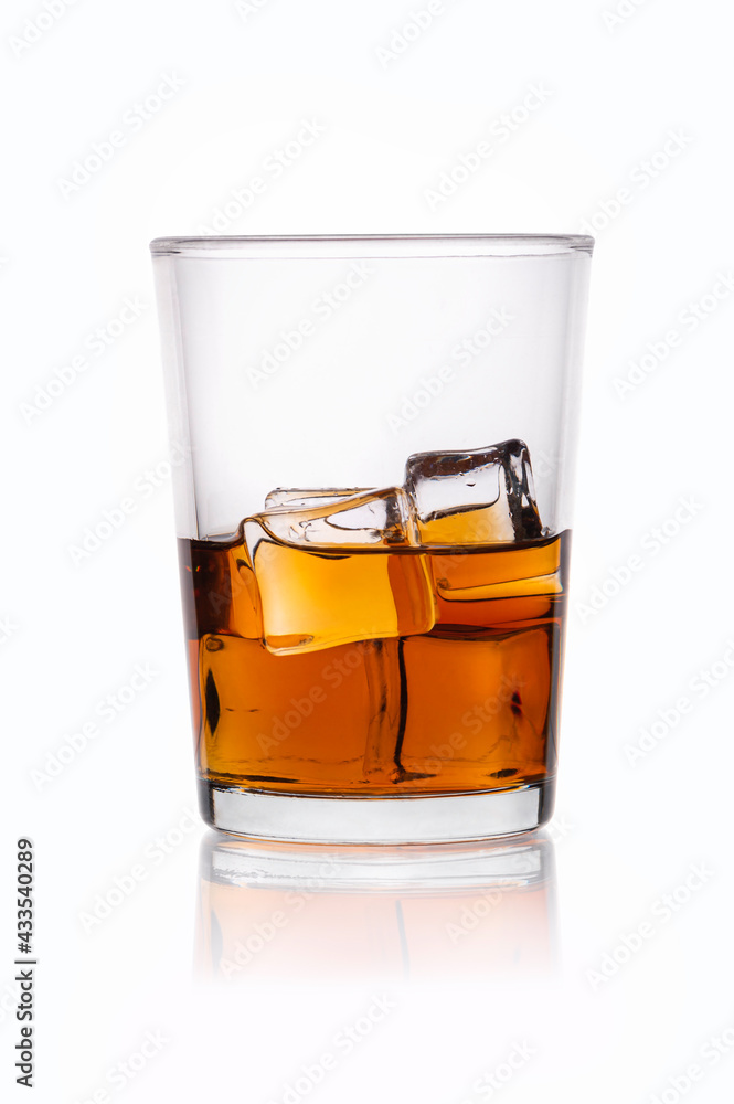 Glass of whiskey and ice isolated on white background.