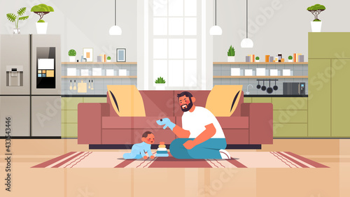 young father playing with little son at home fatherhood parenting concept dad spending time with his kid