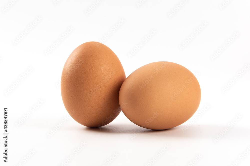 Raw brown chicken eggs on white background Raw brown chicken eggs on white background
