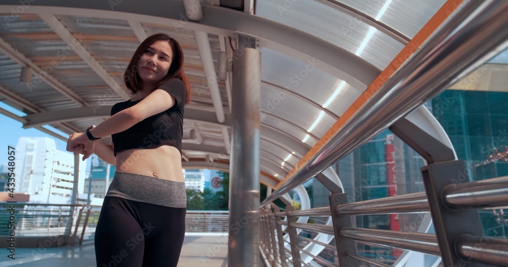 Healthy sport Asian young women stretching body warm up before workout outdoor. female in sportswear happy nice girl resting outside gym. Exercise to prevent the coronavirus and New normal concept Healthy sport Asian young women stretching body warm up before workout outdoor. female in sportswear happy nice girl resting outside gym. Exercise to prevent the coronavirus and New normal concept