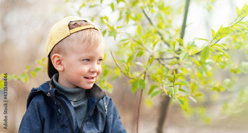 smiling kid in a cap in the park smiling kid in a cap in the park