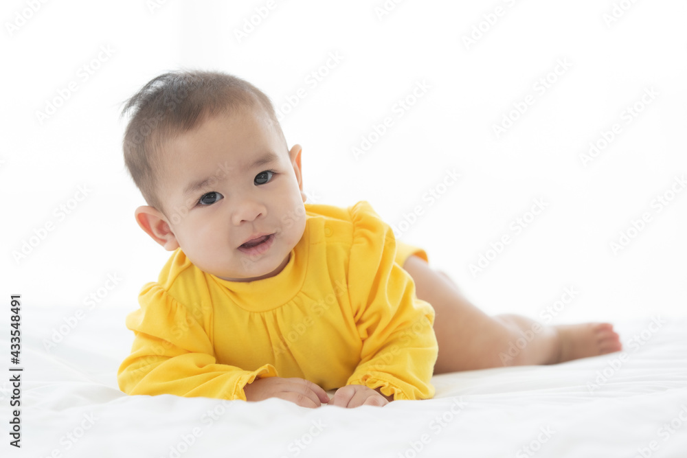 Portrait and focus to eye adorable baby child on white bed in bedroom look at camera with bright soft light in morning in background Portrait and focus to eye adorable baby child on white bed in bedroom look at camera with bright soft light in morning in background