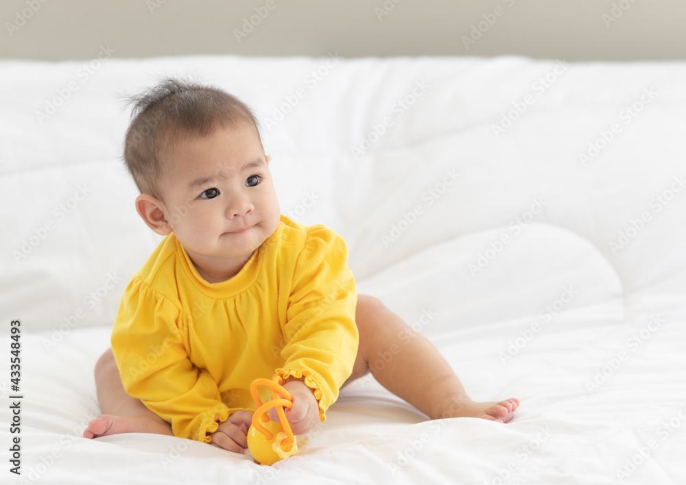 Portrait and focus to eye adorable baby child on white bed in bedroom look at camera with bright soft light in morning in background Portrait and focus to eye adorable baby child on white bed in bedroom look at camera with bright soft light in morning in background