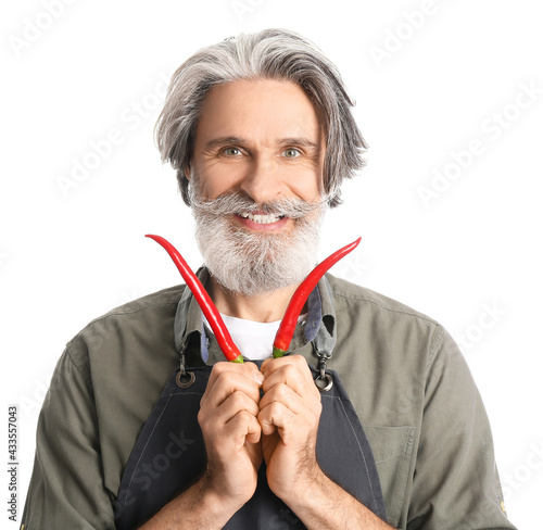 Senior man with chili peppe...