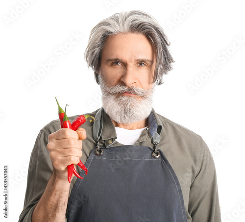 Senior man with chili peppe...