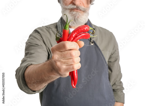 Senior man with chili peppe...