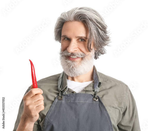 Senior man with chili peppe...