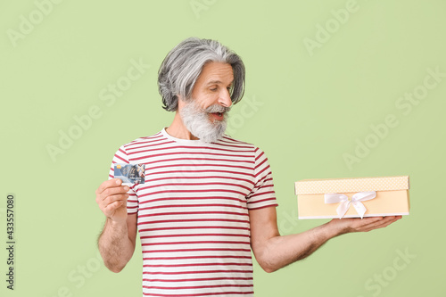 Surprised senior man with g...
