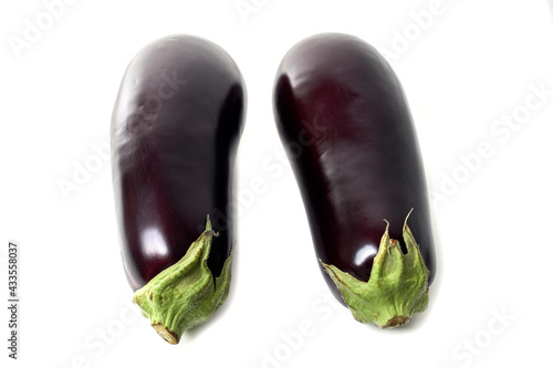Two eggplants with green sepals isolated on white background