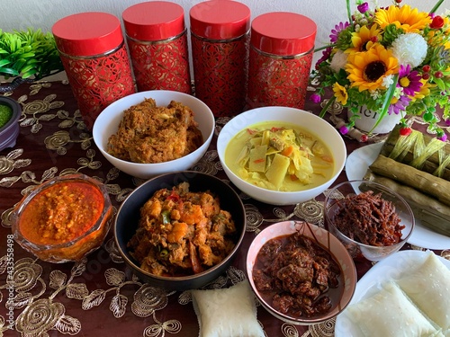 Celebrating Eid ul-Fitr with Malaysian delicacies such as chicken rendang, peanut sauce also known as kuah kacang, anchovies sambal, ketupat and burasak. A popular traditional  Malay food from asia.  photo