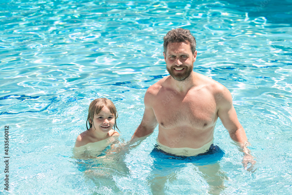 Father and son swimming in pool. Swimming lessons. Family summer weekeng. Dad and son in pool.