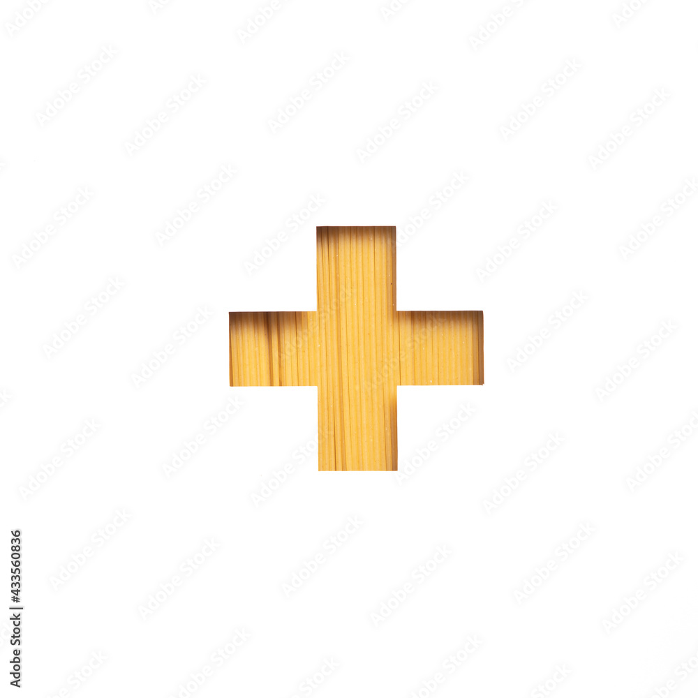 Obraz premium Plus summation sign or cross made of spaghetti pasta and white cut paper. Typeface. Healthy dieting and calories control