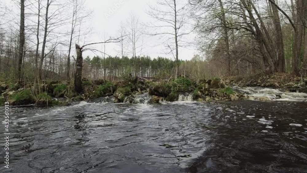 The view from the kayak from the water to the small rapids in the forest river. High quality FullHD 50 fps footage The view from the kayak from the water to the small rapids in the forest river. High quality FullHD 50 fps footage