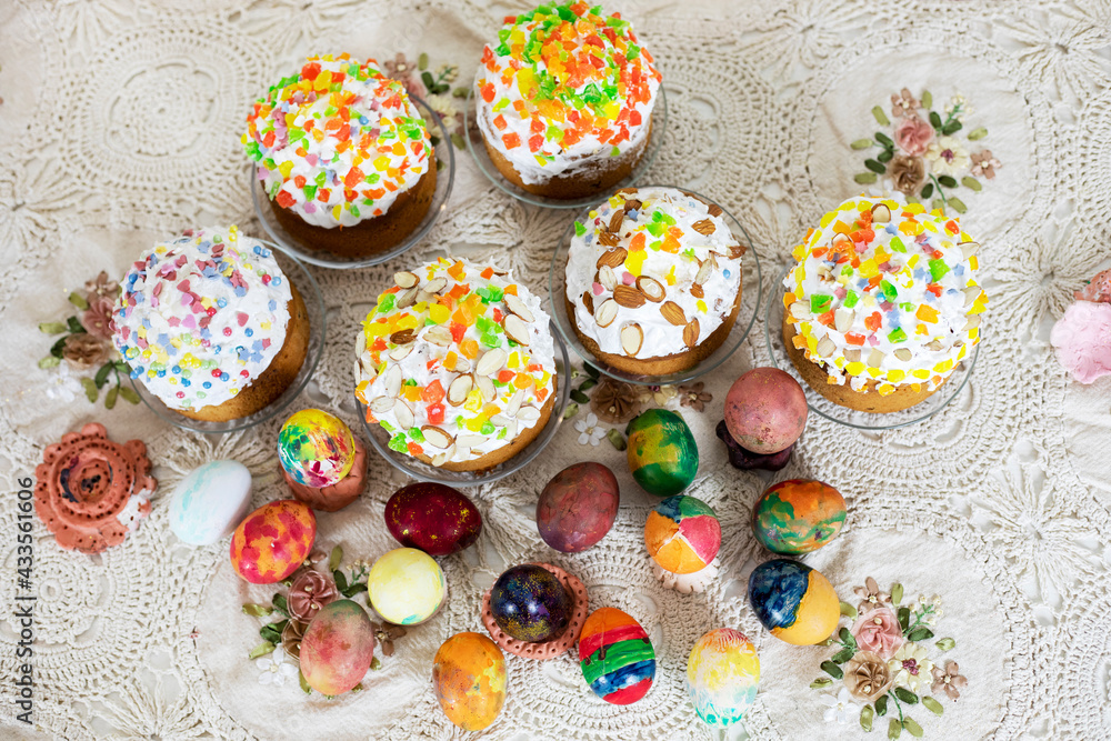 Easter cakes with Easter eggs on a vintage tablecloth, preparation for the holiday. view from above.