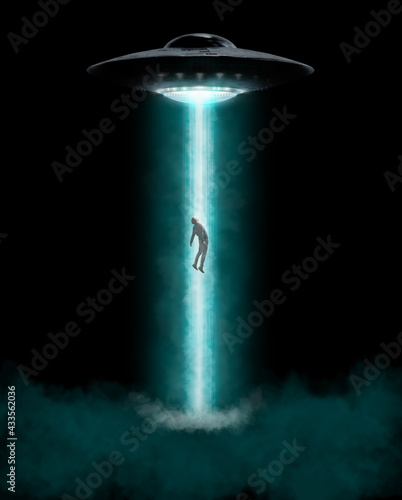 Man being abducted by UFO photo