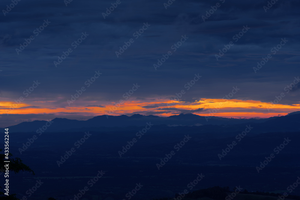 dark spooky gloomy clouds and large mountain sky at sunset background wallpaper dark spooky gloomy clouds and large mountain sky at sunset background wallpaper