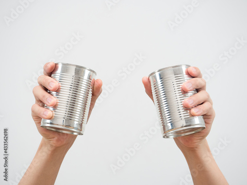 Closeup man hand holding metal can on white isolated background