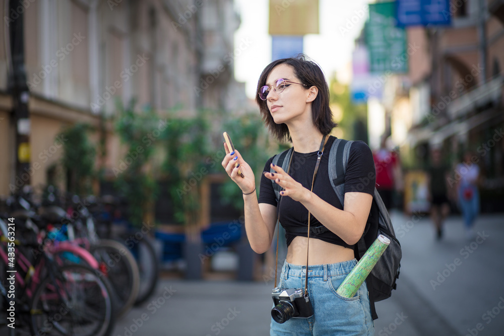 Tourist woman on the street holding phone. Tourist woman on the street holding phone.