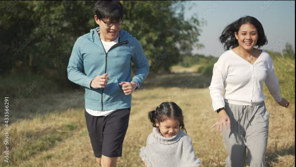 Happy Asian family workout in park. Parents with little daughter enjoy exercising and playing together. Father and mother with cute child girl kid having fun outdoor lifestyle and weekend activity. Happy Asian family workout in park. Parents with little daughter enjoy exercising and playing together. Father and mother with cute child girl kid having fun outdoor lifestyle and weekend activity.