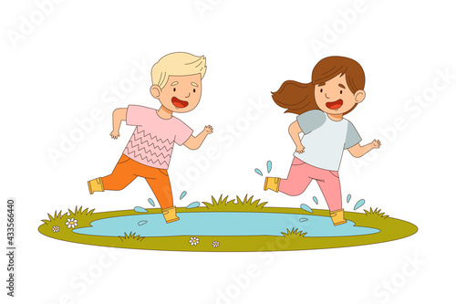 Cheerful Boy and Girl in Yellow Rubber Boots Enjoying Spring Season Splashing in Puddle Vector Illustration