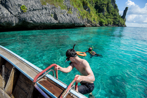 Photography An active man on thai traditional longtail Boat is ready to snorkel and dive, Ph