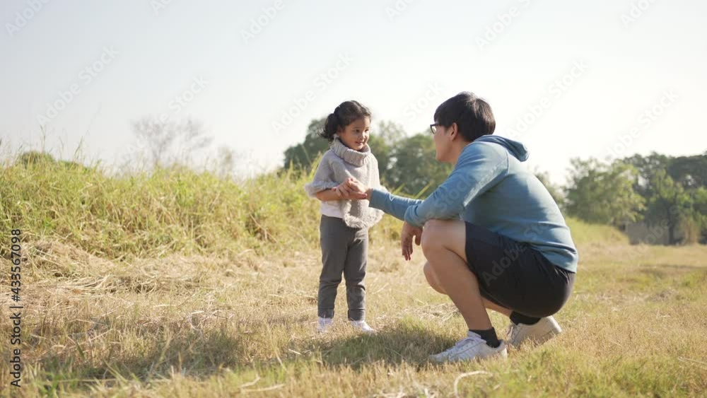 Happy Asian family workout in park. Parents with little daughter enjoy exercising and playing together. Father and mother with cute child girl kid having fun outdoor lifestyle and weekend activity. Happy Asian family workout in park. Parents with little daughter enjoy exercising and playing together. Father and mother with cute child girl kid having fun outdoor lifestyle and weekend activity.